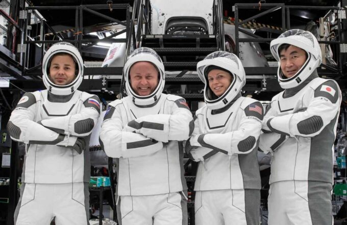 The four experienced astronauts posing for a photo in their spacesuits before the launch of their mission