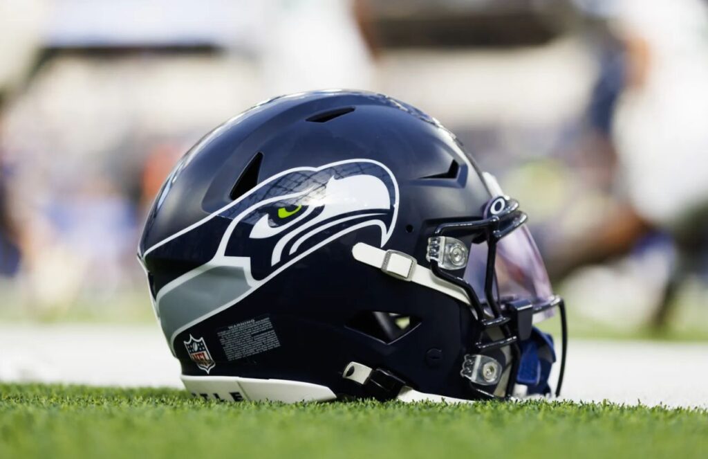 NFL in shock: Seattle to play the super bowl and be put up for sale A Seattle Seahawks helmet placed on the grass of a football field