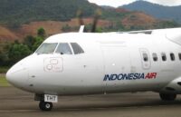An Indonesia Airlines aircraft parked on the runway of an airport