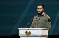 The leader of the Kurdish militias speaking at a conference in front of several people