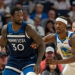 Julius Randle protecting the ball while Jimmy Butler tries to defend him and keep him away from the basket