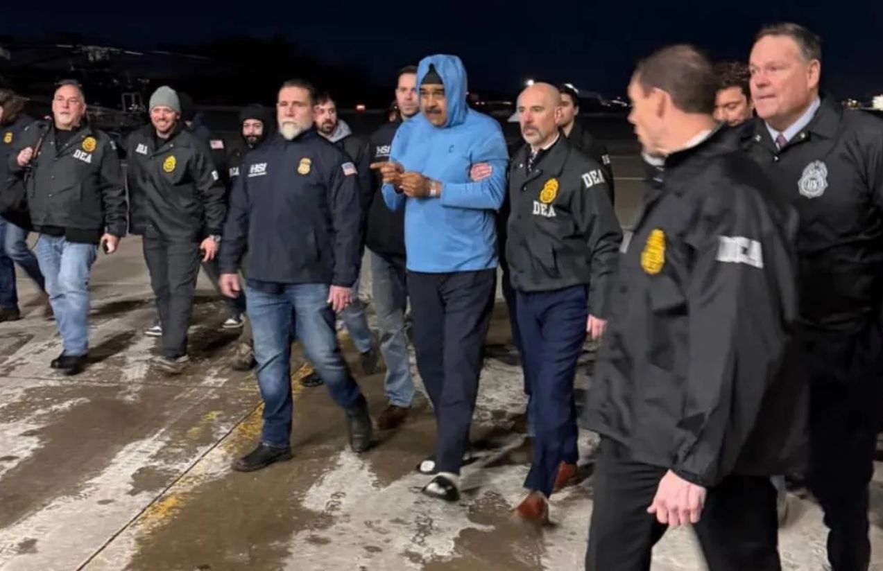Maduro handcuffed while being escorted by numerous U.S. agents