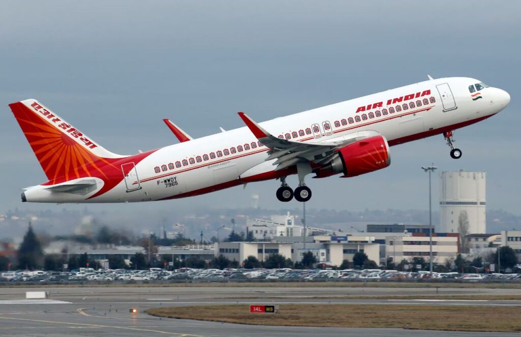 A large white and red airplane taking off from an airport