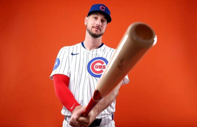 The powerful hitter posing while holding his bat with both hands, wearing the Cubs uniform