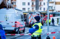 Police officers and emergency responders outside the bar where the tragedy occurred in Switzerland