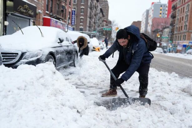 A person clearing snow from the streets as snowfall continues in the United States