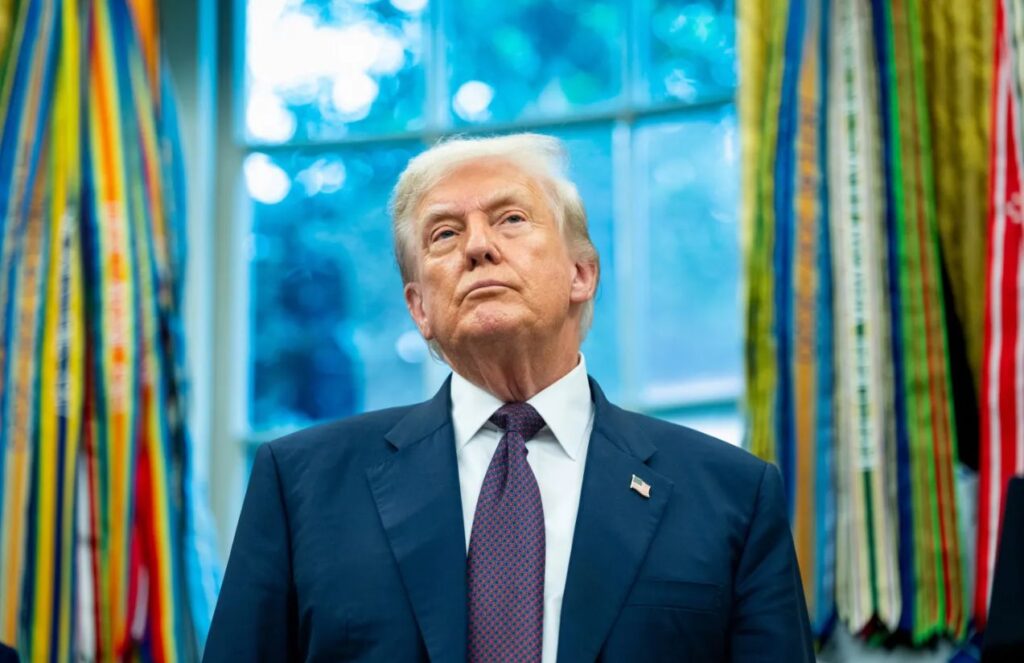 Trump invests millions in Netflix and Warner Bros ahead of a possible mega deal Donald Trump in his office with a very serious expression, shot from a slightly low angle