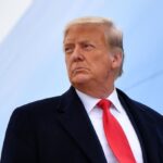 Donald Trump with a very serious expression, looking to one side