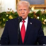 Donald Trump standing at a podium at the White House, waiting to deliver his speech after the incident involving Nicolás Maduro