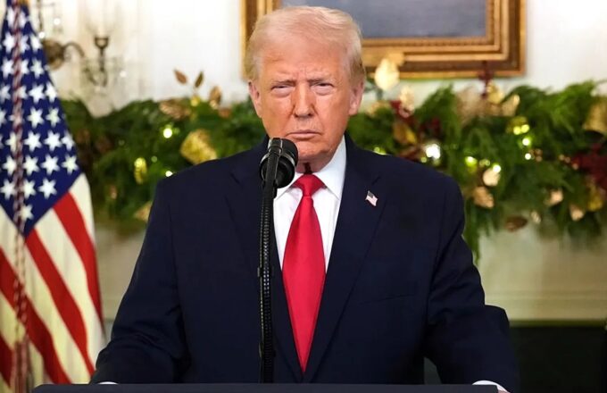Donald Trump standing at a podium at the White House, waiting to deliver his speech after the incident involving Nicolás Maduro