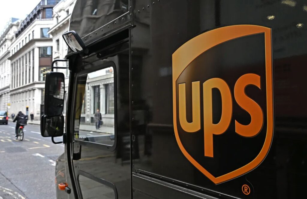 A UPS truck parked with the company’s logo on each of its sides