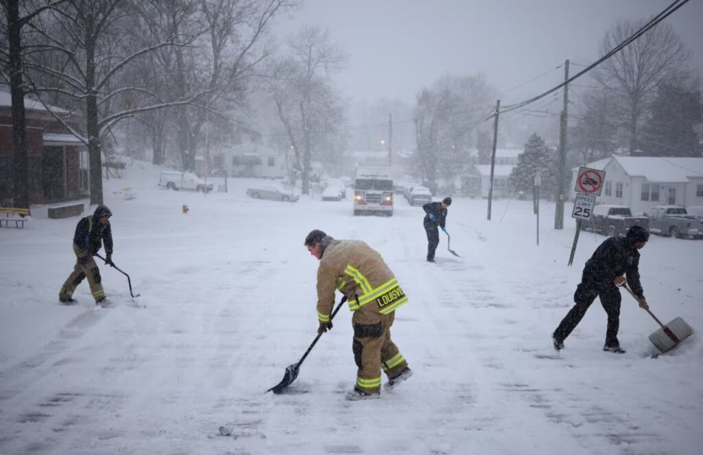 Four people clearing the roads with shovels after the recent snowstorms hitting the United States