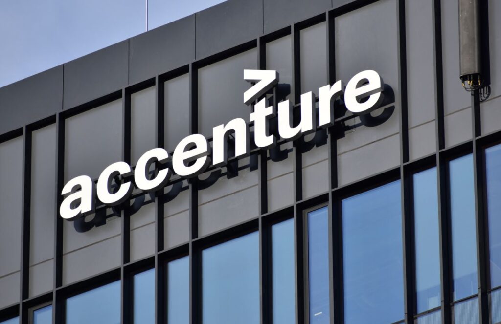 A photo of the company’s offices with the corporate logo at the top of the building and large glass windows throughout