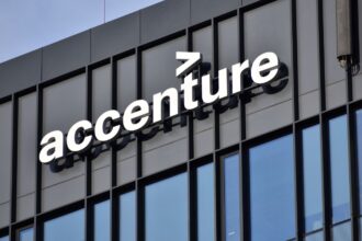 A photo of the company’s offices with the corporate logo at the top of the building and large glass windows throughout