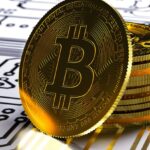 A physical Bitcoin coin with its well-known logo printed on it