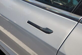 A gray car door with a hidden door handle