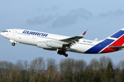 A Cuban airline aircraft taking off in white, blue, and red colors