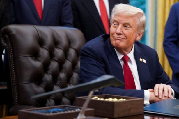 Donald Trump seated in his presidential office surrounded by many people