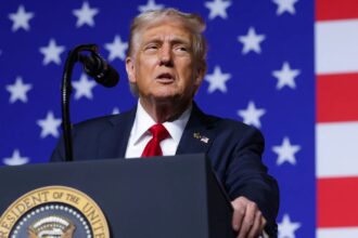 Donald Trump speaking to the crowd during an event