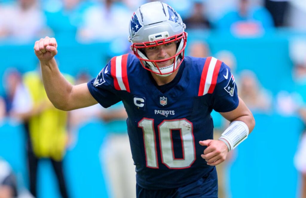 Drake, euphoric after delivering a great pass, celebrating with his right arm raised
