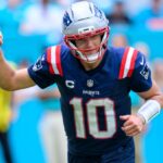 Drake, euphoric after delivering a great pass, celebrating with his right arm raised