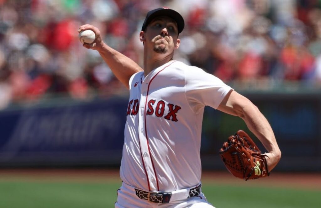 Former Dodgers world series champion pitcher signs new deal with the Padres The now Padres player about to throw the ball from the mound while wearing a Boston Red Sox uniform