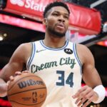 The Greek Freak holding the basketball to inbound the ball in the middle of a game