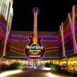 A panoramic view of the incredible hotel from the outside, featuring its iconic guitar-shaped structure