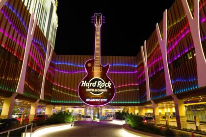 A panoramic view of the incredible hotel from the outside, featuring its iconic guitar-shaped structure