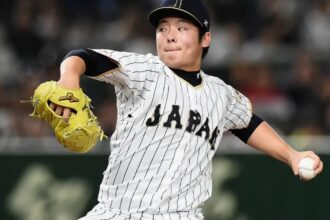 The Japanese left-handed pitcher about to throw a ball while wearing his national team uniform