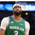 Davis wearing the green Mavericks uniform in the middle of a game while controlling the ball