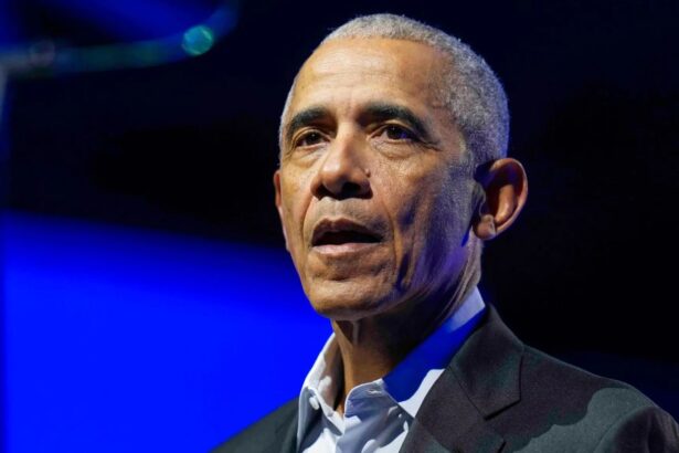 Obama wearing an elegant suit at a major event, speaking to an audience that has his full attention