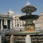 A beautiful panoramic view of St. Peter’s Square with some visitors in it