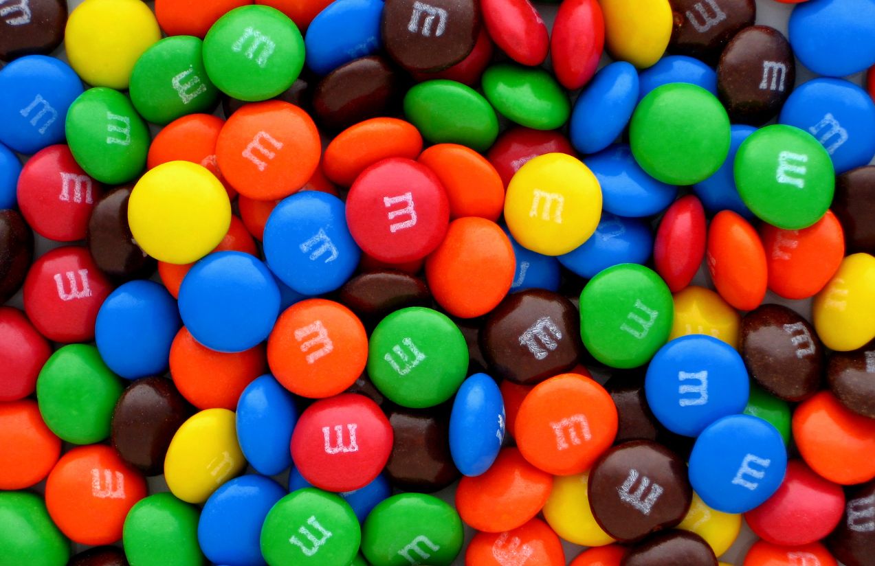 A bag full of M&M’s in all colors, blue, green, yellow, and red