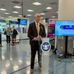 One of Miami Airport’s officials speaking in front of the audience at the inauguration of this new system