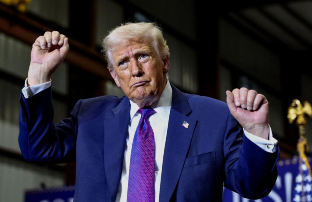 Trump celebrates joyfully, raising both arms over what happened at the Peace Council