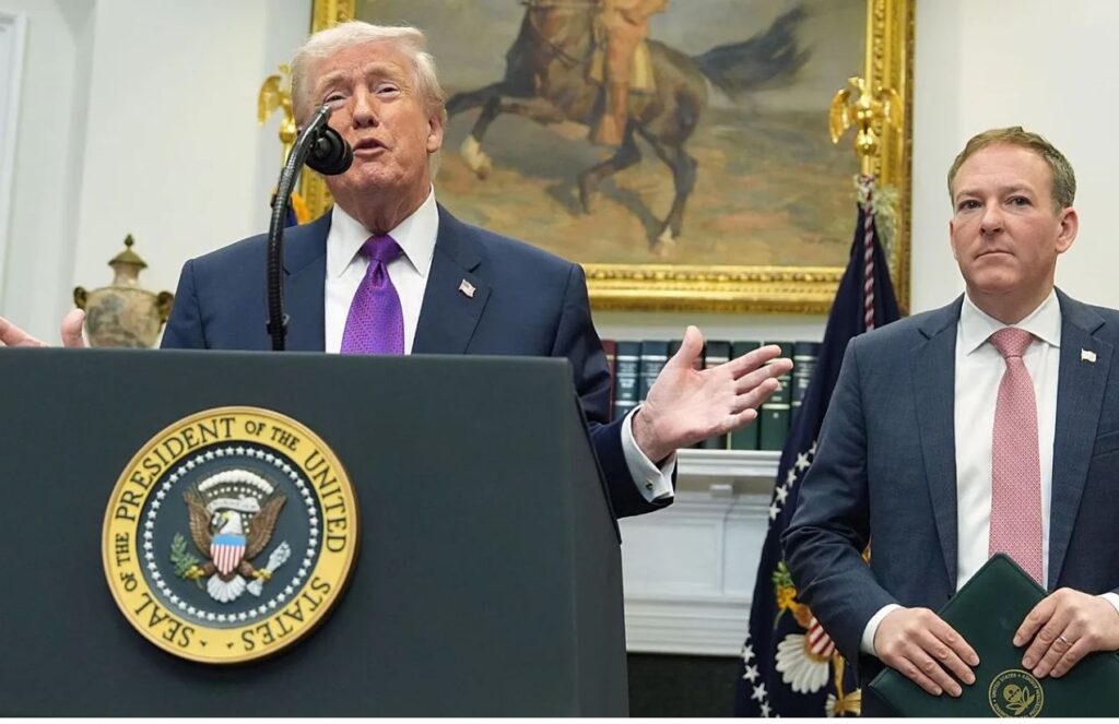 Trump addressing his supporters at the White House, delivering a speech with one of his staff members by his side