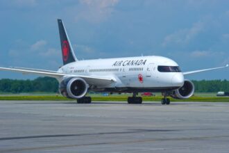A white Air Canada airplane parked at an airport