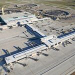 A panoramic aerial view of Kansas City Airport with its terminals and airplanes