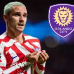 The famous French player kissing the crest on his jersey, with the purple crest of Orlando City SC next to him