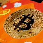 The Bitcoin logo placed on an orange table