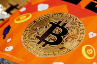 The Bitcoin logo placed on an orange table