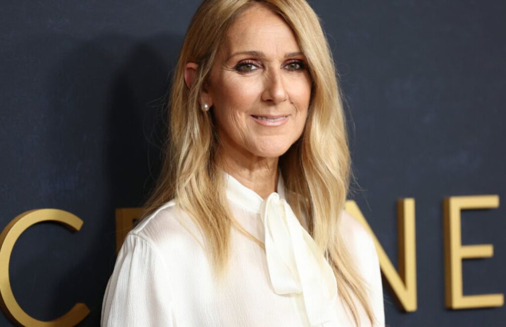 Celine Dion posing on a red carpet before one of her concerts