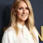 Celine Dion posing on a red carpet before one of her concerts