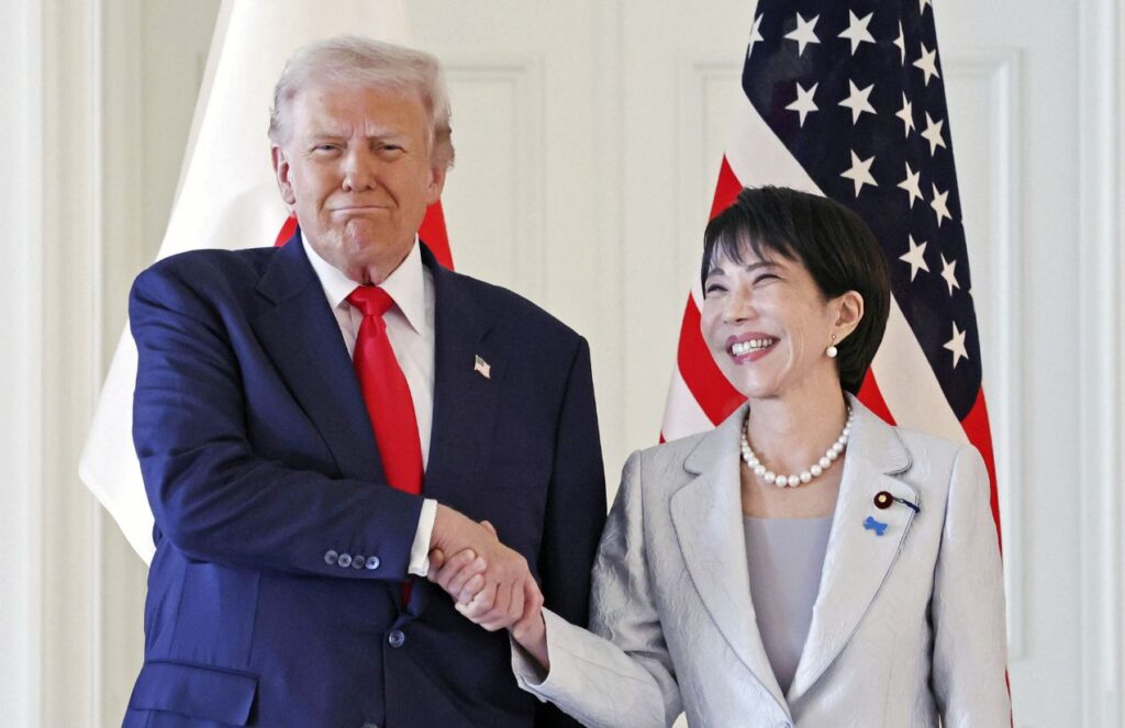 The U.S. president and the Japanese prime minister happily shaking hands for a photo