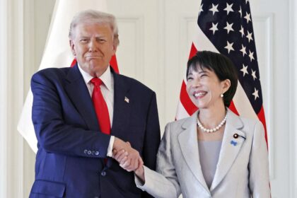 The U.S. president and the Japanese prime minister happily shaking hands for a photo
