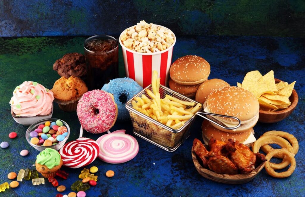 Different types of junk food all together on the floor