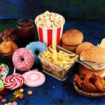 Different types of junk food all together on the floor