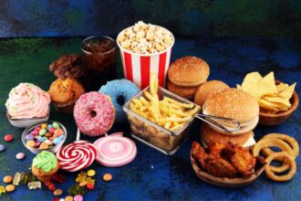 Different types of junk food all together on the floor
