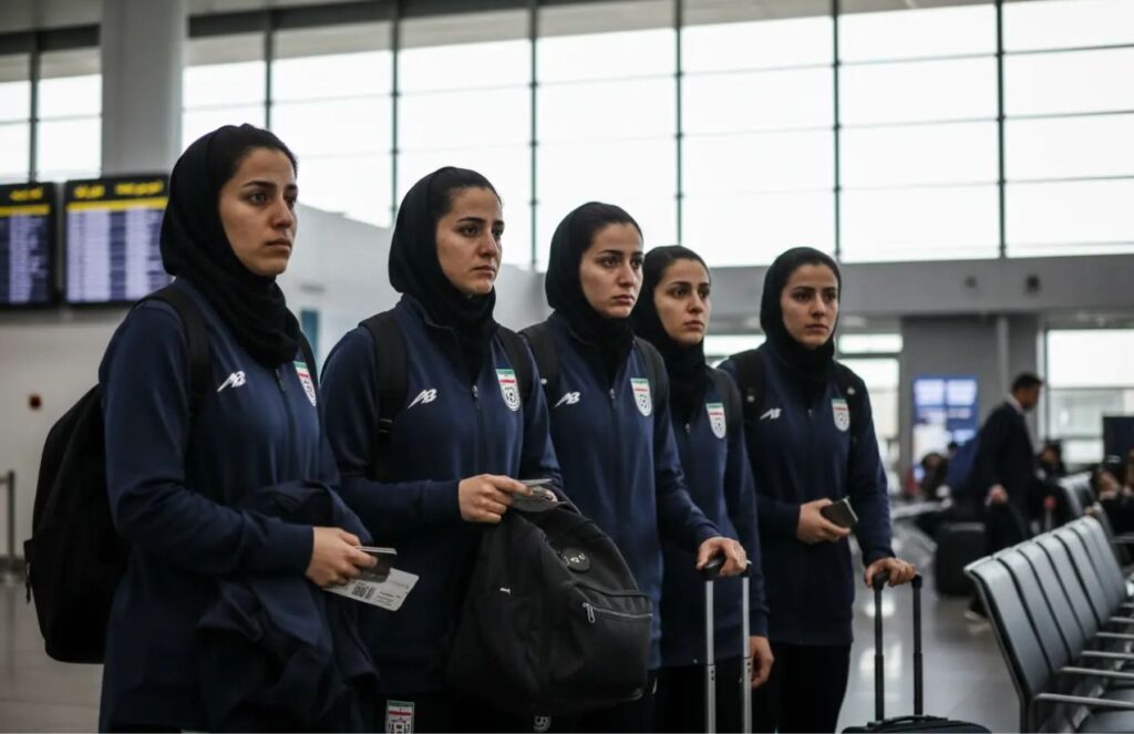 Several female players from the Iranian national soccer team with worried expressions at an airport